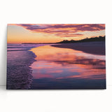 Stretched canvas artwork showcasing a vibrant beach landscape with vivid blue skies and golden sand, leaning against a neutral wall, perfect for home decor.