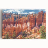 Stretched canvas artwork depicting a stunning landscape of colorful canyons under a clear blue sky, ideal for home decor and nature enthusiasts.