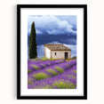 Framed landscape artwork depicting a serene countryside scene, featuring a black frame and matting, ideal for enhancing home decor aesthetics.