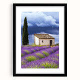 Framed landscape artwork depicting a serene countryside scene, featuring a black frame and matting, ideal for enhancing home decor aesthetics.