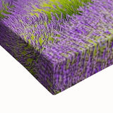 Close-up of a stretched canvas artwork depicting a vibrant countryside landscape, showcasing lush green fields and a serene blue sky with soft clouds, ideal for home decor.