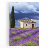 Stretched canvas artwork depicting a serene countryside landscape with rolling hills, vibrant greenery, and a clear blue sky, ideal for home decor.