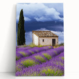 Stretched canvas artwork depicting a serene countryside landscape with rolling hills, vibrant greenery, and a clear blue sky, ideal for home decor.