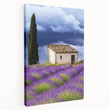 Stretched canvas artwork depicting a serene countryside landscape, showcasing rolling hills, vibrant green fields, and a clear blue sky, ideal for home decor.