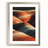 Framed desert landscape artwork showcasing vibrant hues of orange and gold, elegantly matted with a silver frame, perfect for home decor or office aesthetics.