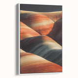 Framed canvas artwork depicting a serene desert landscape with soft hues of beige and orange, showcasing a white frame and side view for elegant home decor.