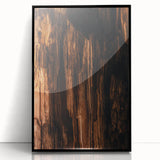 Large abstract wall art with vibrant orange and yellow tones on acrylic, framed in black, ideal for modern living room decor.