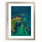 Framed landscape artwork depicting a dramatic cliff scene, featuring silver accents and a mat board, ideal for home décor or gallery display.