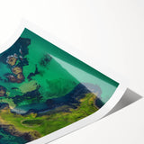 A rolled print depicting a dramatic landscape of rugged cliffs against a vibrant sunset, showcasing rich colors and intricate details, perfect for home decor.