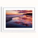 Framed landscape art print showcasing a serene beach scene with soft pastel colors, set in a sleek white mat, perfect for coastal home decor.