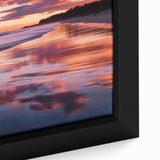 Framed canvas artwork showcasing a serene beach landscape at sunset, with vibrant colors blending orange, pink, and blue hues, ideal for coastal home decor.