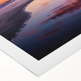 Rolled canvas artwork showcasing a serene beach landscape with vibrant colors and soft waves, elegantly packaged in a robust cardboard tube for safe delivery.