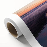 Landscape canvas print showcasing a serene beach scene at sunset, featuring vibrant colors of orange and blue, rolled for easy display and shipping in protective packaging.