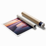 Rolled print showcasing a serene beach landscape with soft pastel colors and gentle waves, elegantly packaged in a protective cardboard tube for safe shipping.