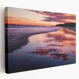 Stretched canvas artwork displaying a vibrant beach landscape, showcasing bright blue skies, golden sands, and lush palm trees, ideal for coastal-themed decor.
