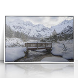 Framed acrylic landscape artwork depicting a serene bridge scene with lush greenery, set against a bright blue sky, ideal for home or office decor.