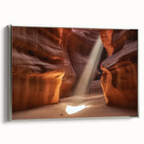 Framed canvas artwork depicting a stunning landscape of canyons with rich earth tones and silver framing, ideal for enhancing home decor or office spaces.