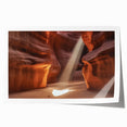 Vibrant landscape print depicting majestic canyons in warm hues of orange and red, rolled and ready for display, perfect for enhancing home decor aesthetics.