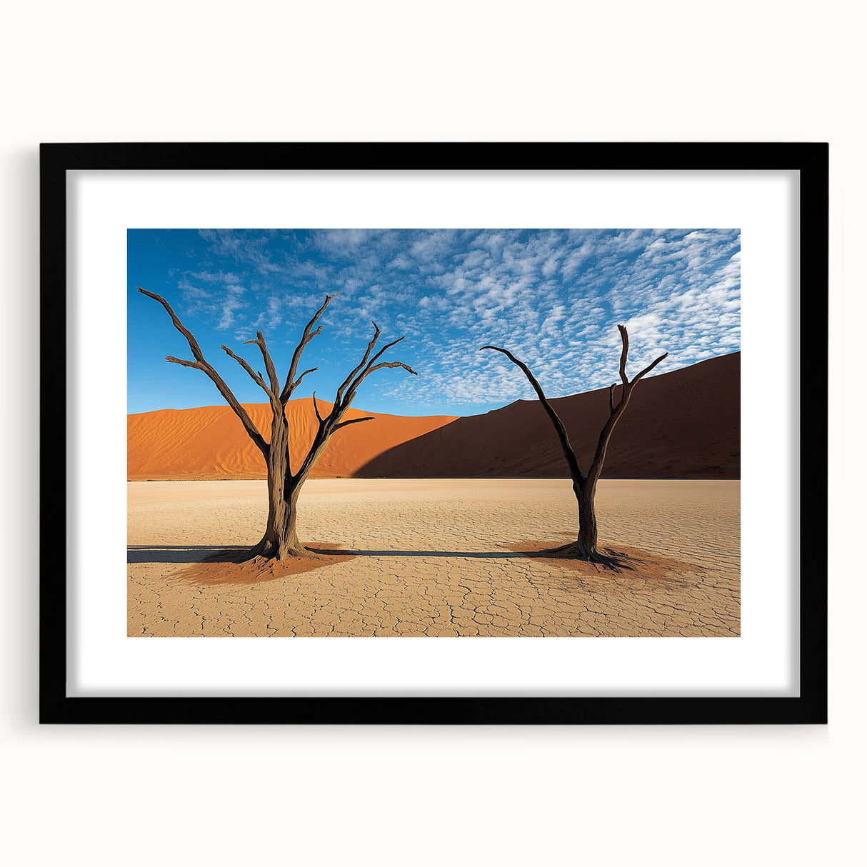 Framed landscape artwork depicting a serene desert scene, featuring warm earthy tones and a sleek black mat, perfect for modern home decor. Ideal for enhancing interior spaces with natural beauty.