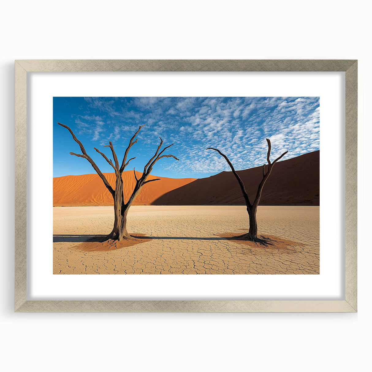 Desert landscape artwork framed in a sleek silver frame with a mat, showcasing warm tones of beige and orange, perfect for enhancing modern home decor.