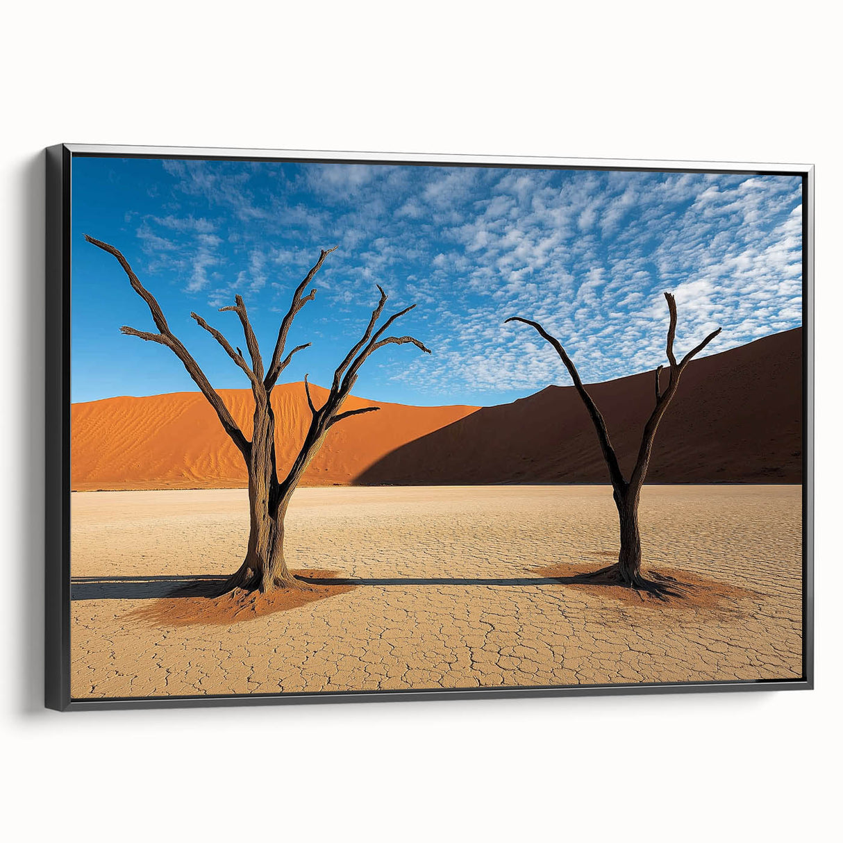 Framed canvas artwork depicting a vibrant desert landscape with warm colors, featuring a black frame and side view display, ideal for home decor.