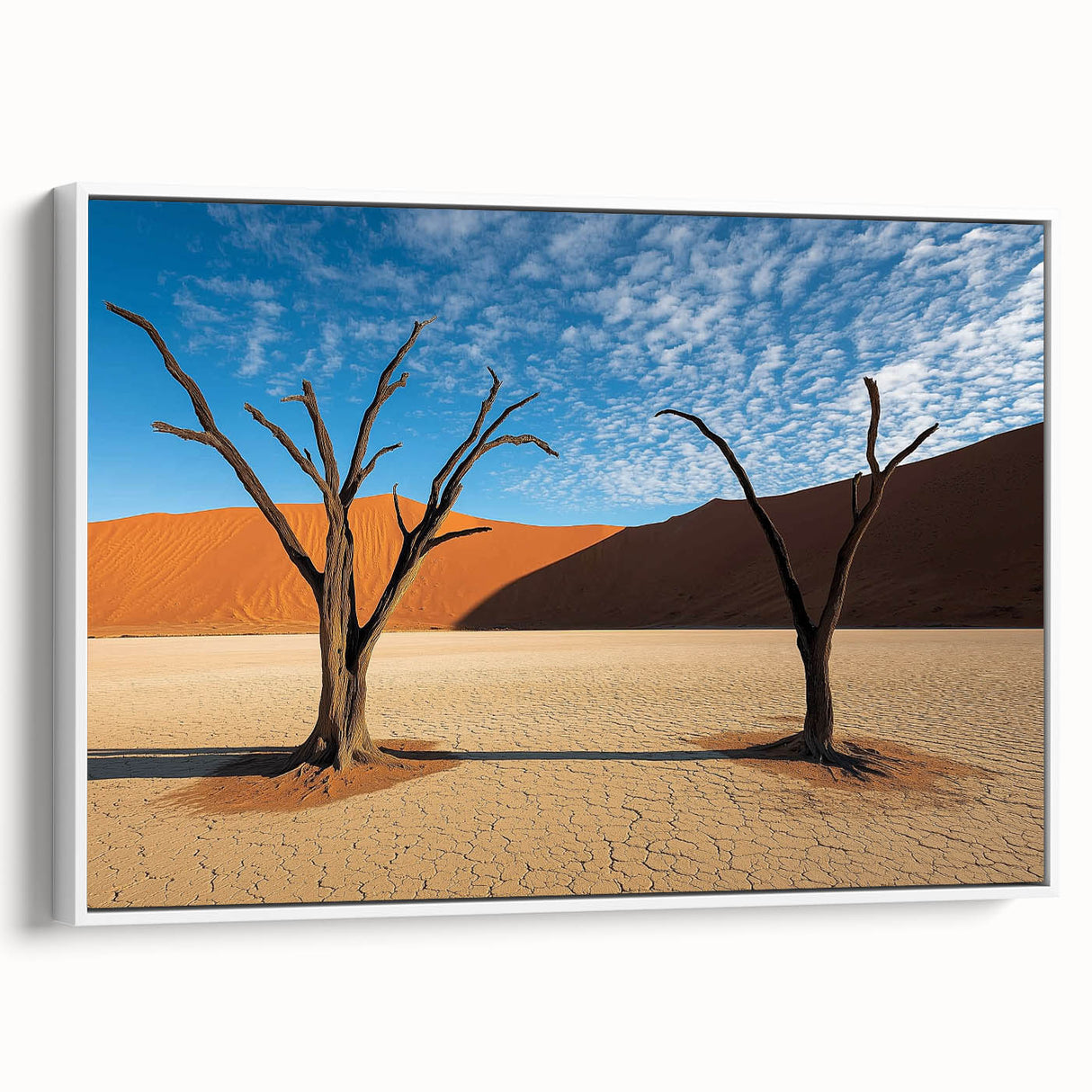 Framed canvas art depicting a serene desert landscape with warm tones of orange and beige, featuring a white frame for a modern touch, ideal for home decor.