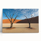 Desert landscape stretched canvas art piece featuring warm hues of orange and yellow, depicting rolling dunes under a clear blue sky, perfect for modern home decor.