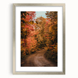 Textured abstract art print in warm autumnal tones on a silver-framed canvas, ideal for bedroom wall decor.