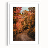 Abstract art print featuring swirling autumn colors in orange and brown on a white framed canvas.