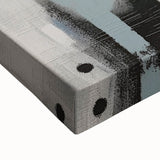 Close-up of an abstract wall art design featuring colorful strokes in rich hues of blue, orange, and yellow on a stretched canvas, enhancing modern decor.