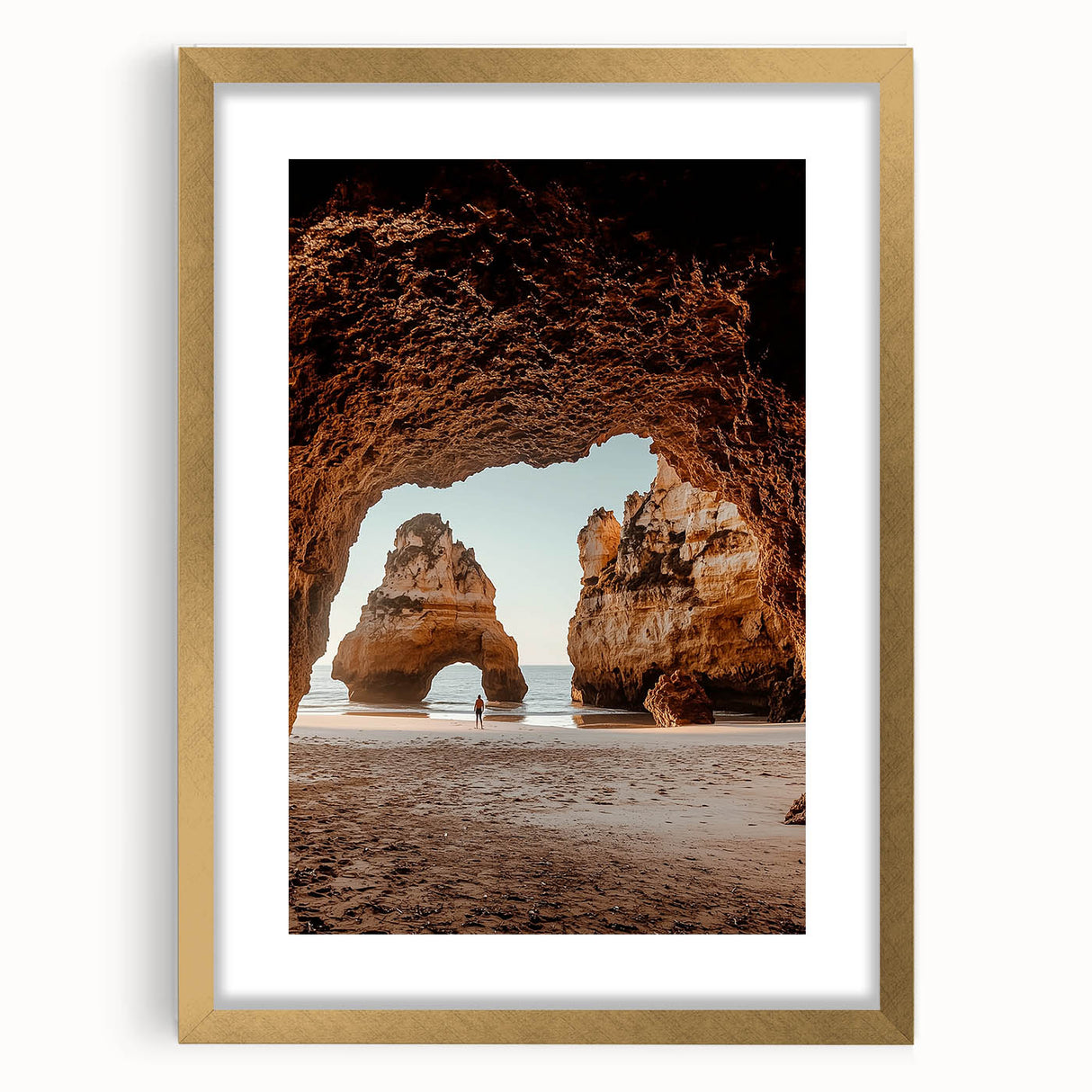 Framed landscape artwork featuring a cave scene, elegantly displayed with a gold mat. The design highlights earthy tones and intricate details, perfect for enhancing home decor.