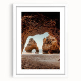Framed landscape artwork depicting a serene cave scene with vibrant colors, set within a white mat. Ideal for home decor, adding a touch of nature's beauty.