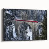 Framed canvas artwork depicting a serene landscape view of a bridge surrounded by lush greenery, showcasing a black frame that enhances the natural beauty of the scene. Perfect for home decor, this piece adds a tranquil touch to any room.