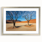 Desert landscape artwork framed in silver with a white mat, showcasing warm tones of sand and sky, ideal for modern home decor. Perfect for nature enthusiasts.