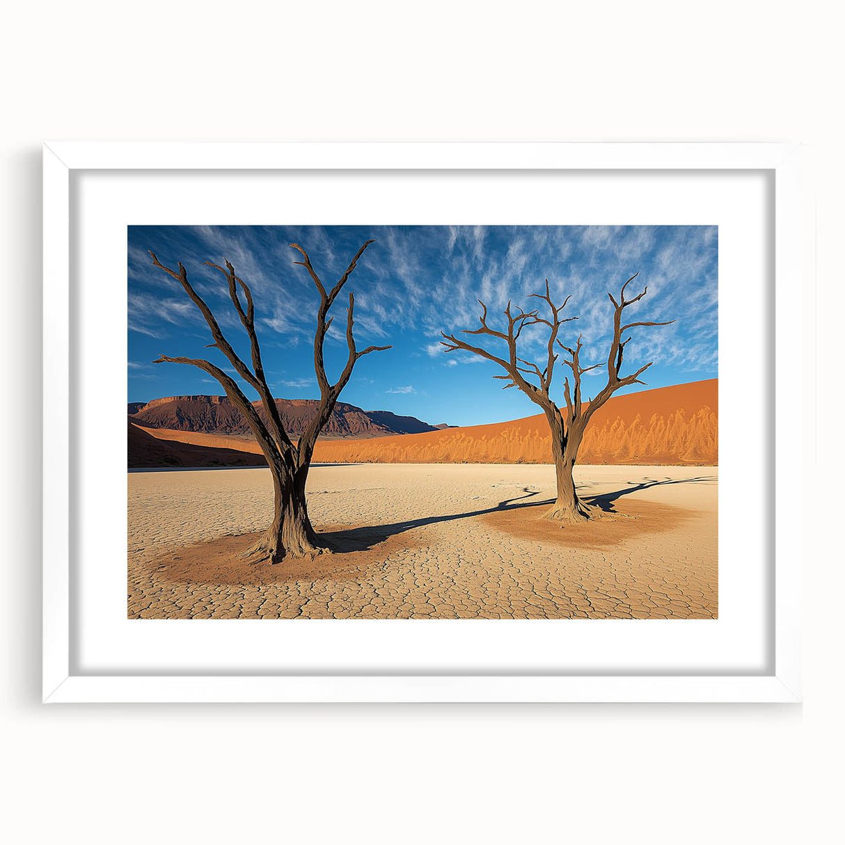 Desert landscape artwork framed in a sleek white mat, showcasing warm earthy tones and intricate details of the arid scenery, perfect for home decor.