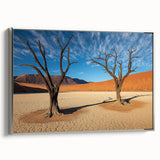 Desert landscape framed canvas artwork showcasing warm hues of orange and yellow under a clear blue sky, featuring a sleek silver frame that enhances the vibrant scene. Perfect for modern home decor, adding a touch of nature-inspired elegance.