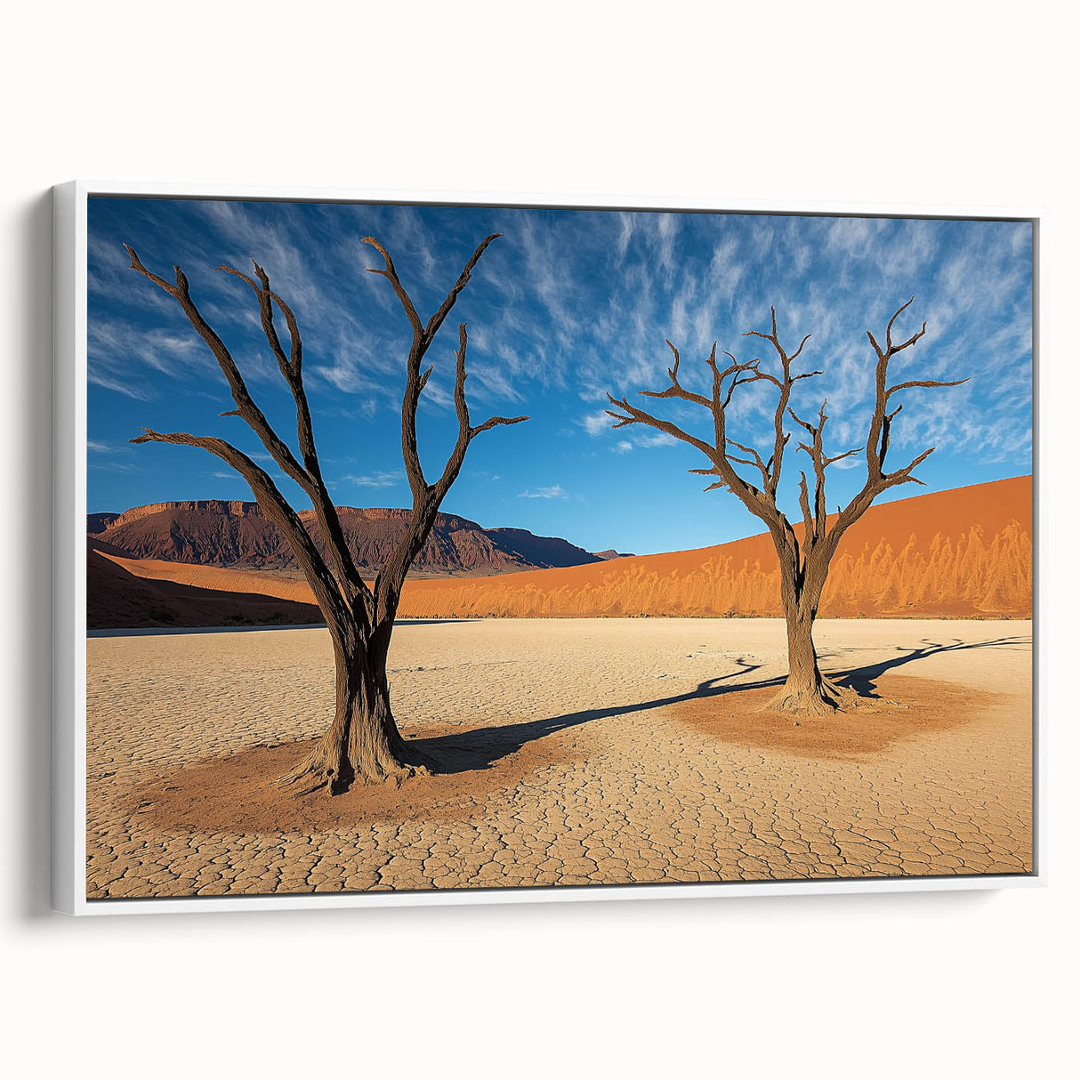 Framed canvas artwork depicting a vibrant desert landscape with warm colors and intricate details, showcased from a white side view for a modern aesthetic.