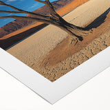 Desert landscape rolled canvas artwork showcasing vibrant warm hues of orange and yellow, depicting a tranquil sunset over arid dunes, ideal for home decor.