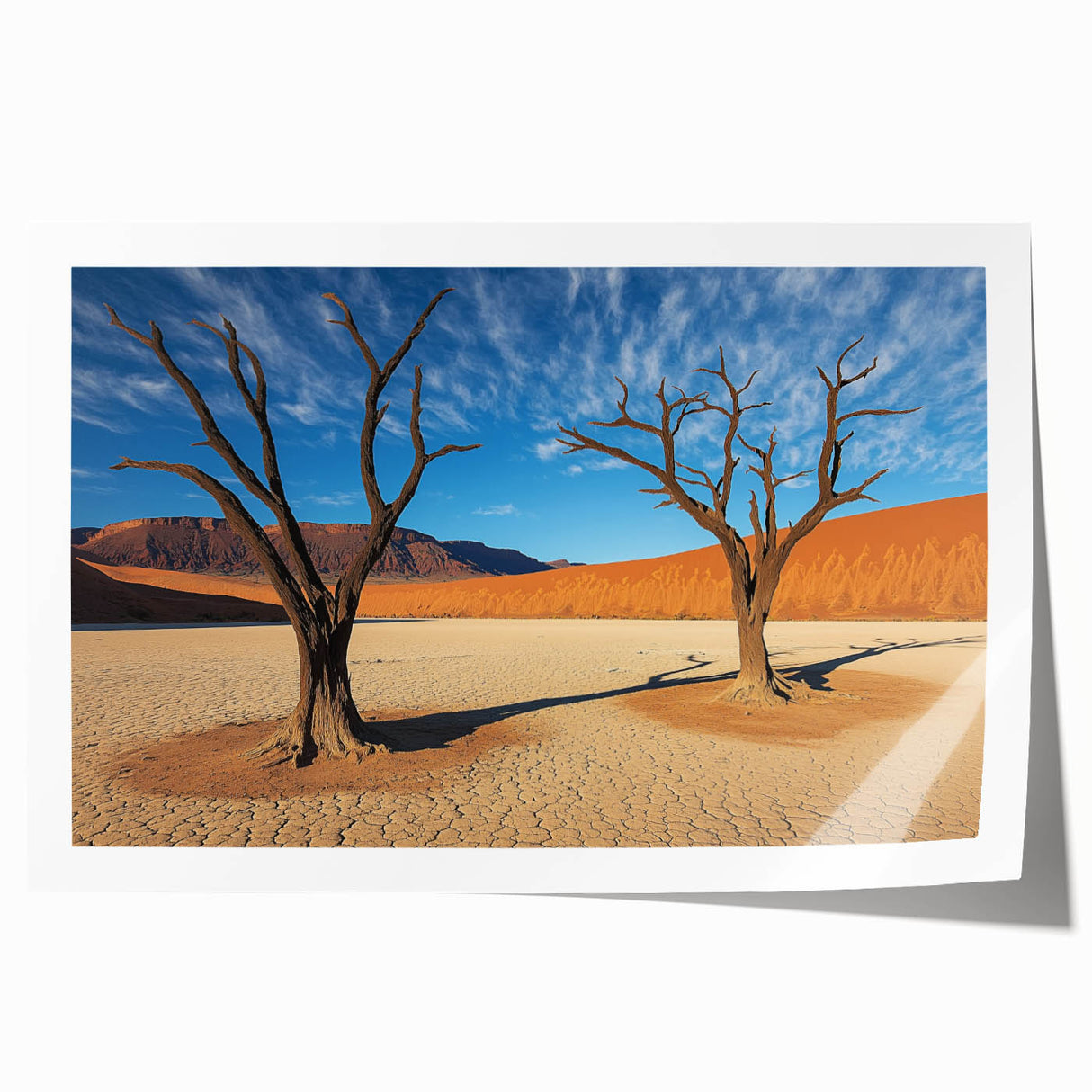 Desert landscape rolled canvas print showcasing vibrant hues of orange and blue, depicting a serene sunset over sand dunes, elegantly packaged in a protective tube.