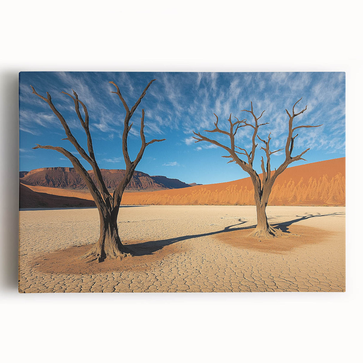 Vibrant stretched canvas artwork depicting a serene desert landscape at sunset, highlighting warm orange and yellow hues against a tranquil blue sky, perfect for home decor.