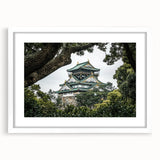 Framed landscape artwork depicting a serene castle scene, featuring a white mat border and elegant wooden frame, ideal for enhancing home decor.