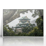 Elegant framed acrylic landscape artwork showcasing a majestic castle surrounded by lush greenery, set against a bright blue sky, perfect for home decor.