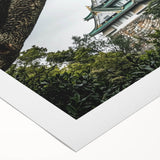 Rolled canvas artwork showcasing a vibrant landscape of a castle surrounded by lush greenery, featuring rich colors and detailed textures, perfect for home decor.