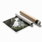 Rolled print showcasing a stunning landscape with a majestic castle surrounded by lush greenery and vibrant skies, elegantly packaged for safe delivery.