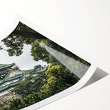 Rolled print showcasing a vibrant landscape of a majestic castle surrounded by lush greenery, perfect for home decor or art enthusiasts, packaged securely for delivery.