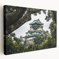 Stretched canvas artwork depicting a scenic landscape with a majestic castle surrounded by lush greenery and a clear blue sky. Ideal for home decor enthusiasts.