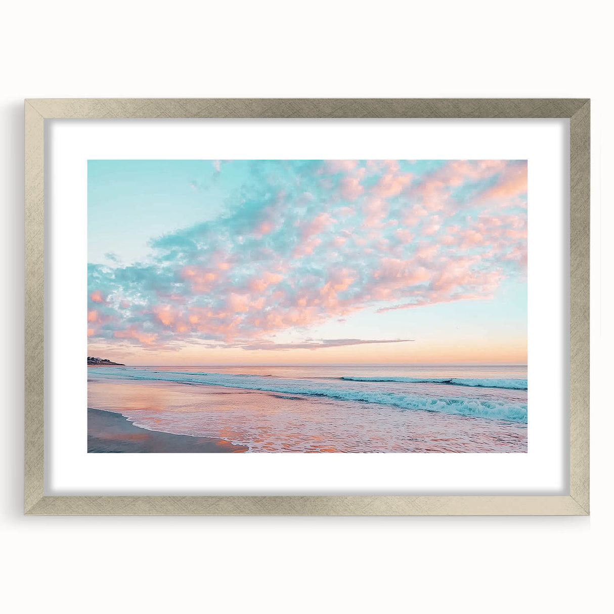 Silver-framed landscape artwork of a serene beach scene with a white mat, designed to enhance home decor and evoke a calming coastal ambiance. Ideal for living rooms or offices.