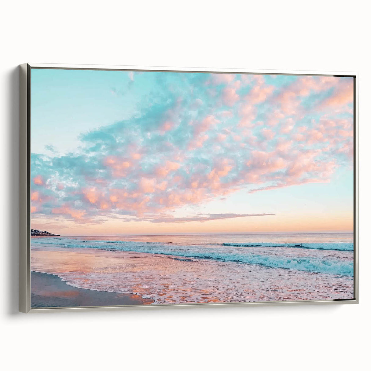 Framed canvas artwork depicting a serene beach landscape, featuring soft pastel colors, a silver frame, and a side view showcasing the artwork's depth and texture. Perfect for coastal home decor.