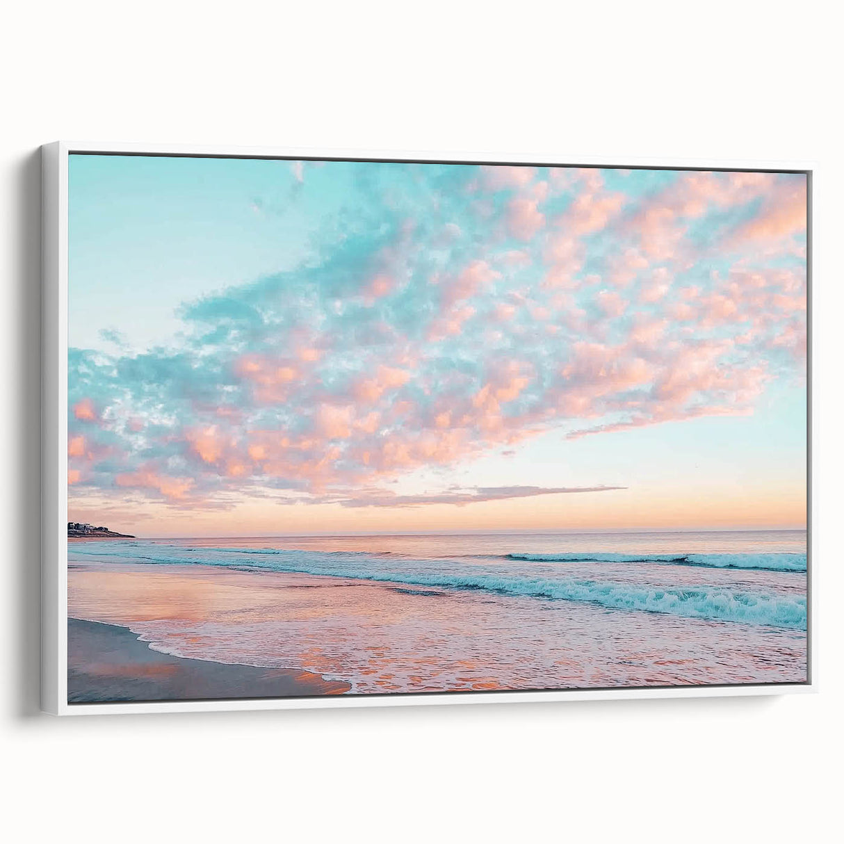 Framed canvas artwork showcasing a serene beach landscape with vibrant colors, displayed in a white frame, perfect for enhancing coastal-themed decor.