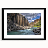 Black-framed landscape print of canyons displayed with a white mat, showcasing vibrant colors and intricate details, perfect for home decor or art enthusiasts.